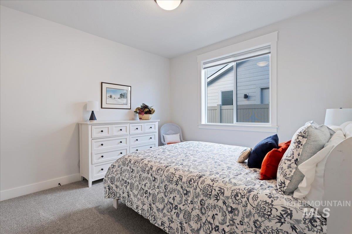 280 North Boulder Rdg Way Eagle, ID 83616 - Photo 24 of 50 Bedroom featuring dark colored carpet and baseboards