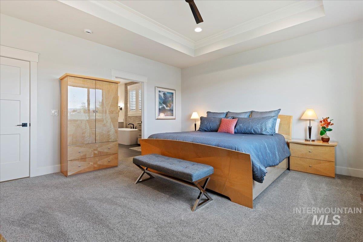 280 North Boulder Rdg Way Eagle, ID 83616 - Photo 33 of 50 Carpeted bedroom with a raised ceiling, ensuite bathroom, ceiling fan, and ornamental molding