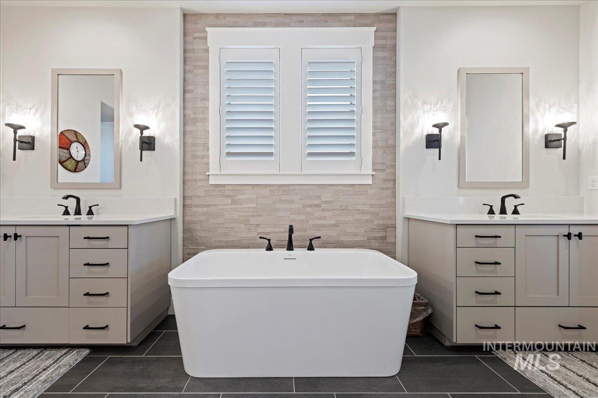 280 North Boulder Rdg Way Eagle, ID 83616 - Photo 35 of 50 Full bathroom featuring two vanities, a soaking tub, and dark tile patterned flooring