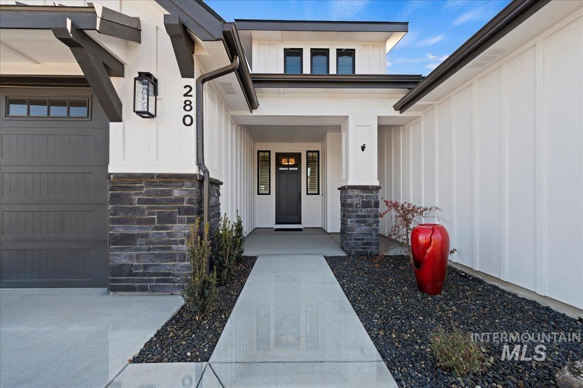 280 North Boulder Rdg Way Eagle, ID 83616 - Photo 4 of 50 Property entrance with board and batten siding, stone siding, and a porch