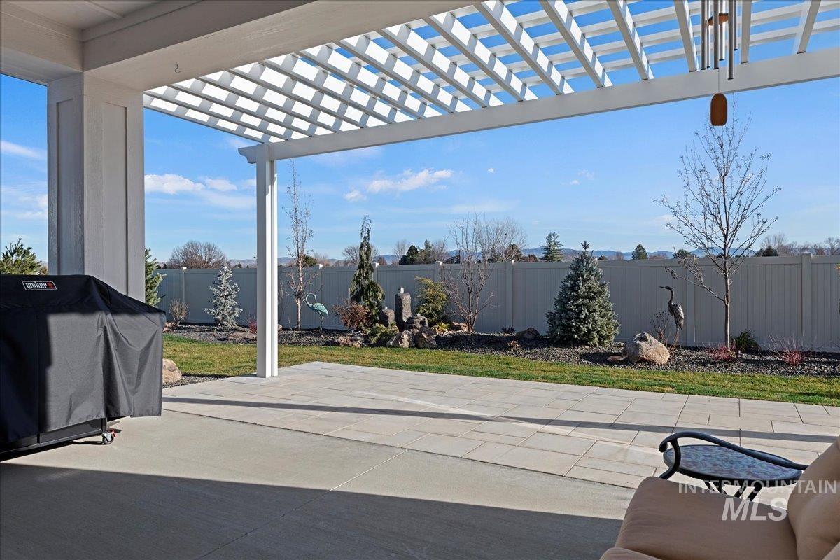 280 North Boulder Rdg Way Eagle, ID 83616 - Photo 45 of 50 Fenced backyard with a pergola, a grill, and a patio area