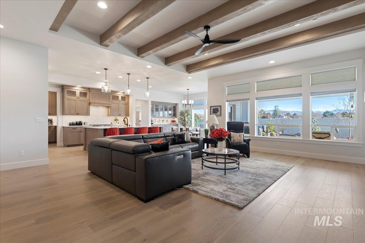 280 North Boulder Rdg Way Eagle, ID 83616 - Photo 7 of 50 Living room featuring a ceiling fan, recessed lighting, a chandelier, beamed ceiling, and light wood finished floors