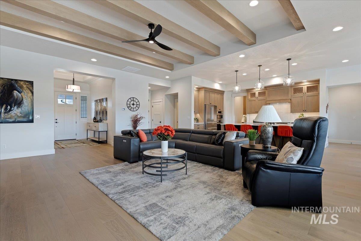280 North Boulder Rdg Way Eagle, ID 83616 - Photo 10 of 50 Living area featuring light wood-style flooring, ceiling fan, recessed lighting, and beamed ceiling