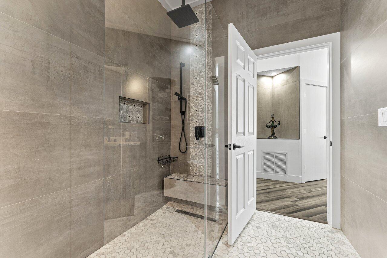 3395 Northwest 53rd Circle Boca Raton, FL 33496 - Photo 15 of 64 a bathroom with a glass shower door