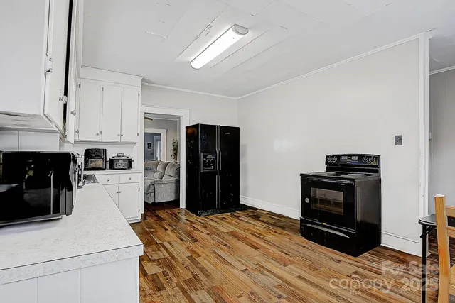 a kitchen with a refrigerator and a stove top oven