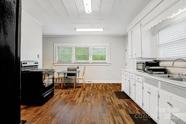 a kitchen with stainless steel appliances a stove a sink a refrigerator and cabinets