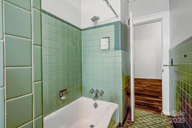 a bathroom with a bathtub and shower