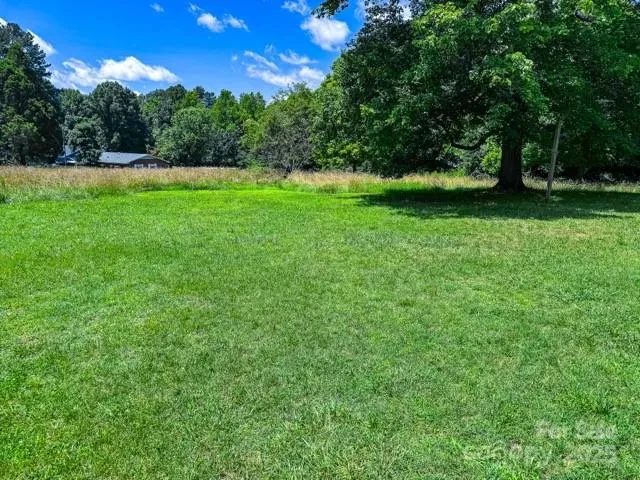 a view of field with trees in the background