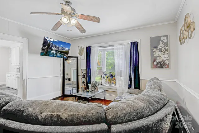 a living room with furniture and a flat screen tv