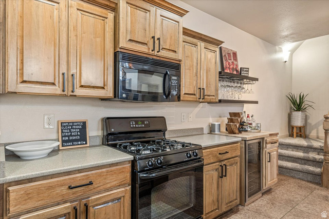 345 North 2450th Street East, Unit 152 St. George, UT 84790 - Photo 12 of 40 Kitchen featuring black appliances, light countertops, and wine cooler