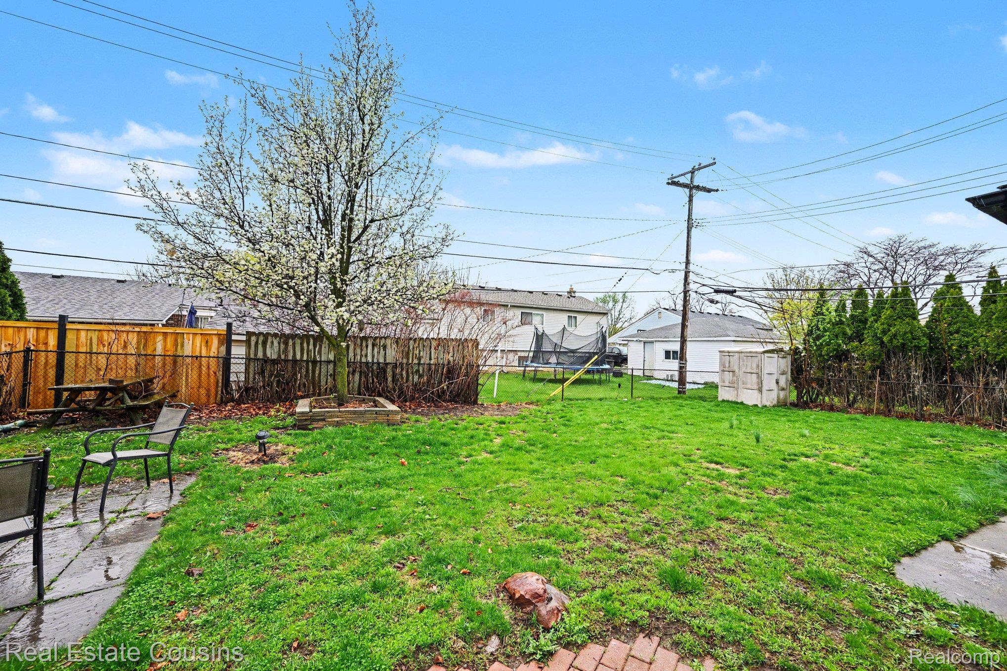 32224 Joy Road Livonia, MI 48150 - Photo 26 of 33 Fenced backyard featuring a trampoline and a patio