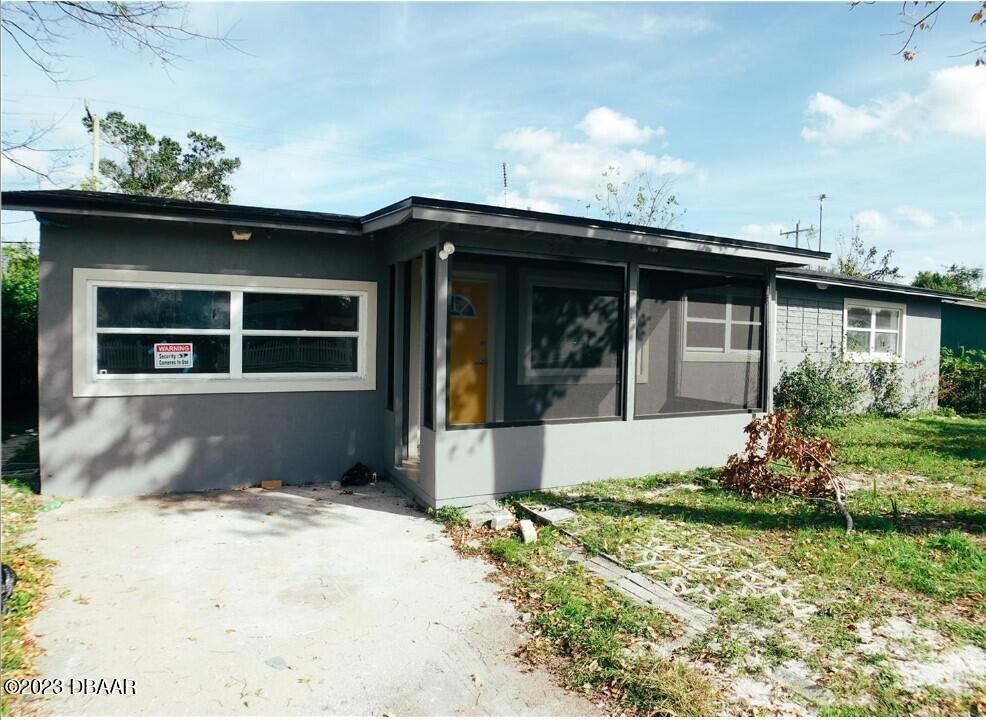 823 Berkshire Road Daytona Beach, FL 32117 - Photo 1 of 13 a front view of a house with a yard