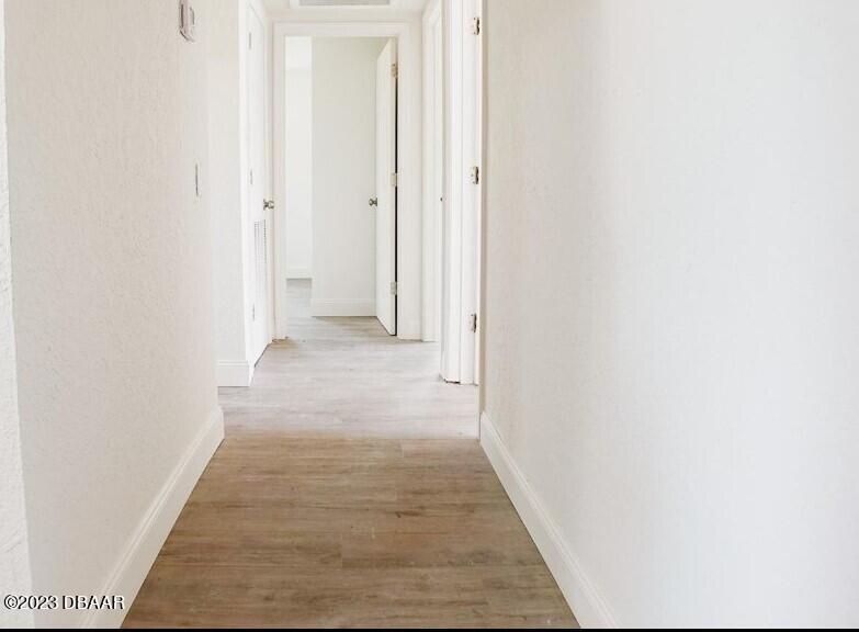 823 Berkshire Road Daytona Beach, FL 32117 - Photo 6 of 13 a view of a hallway with wooden floor
