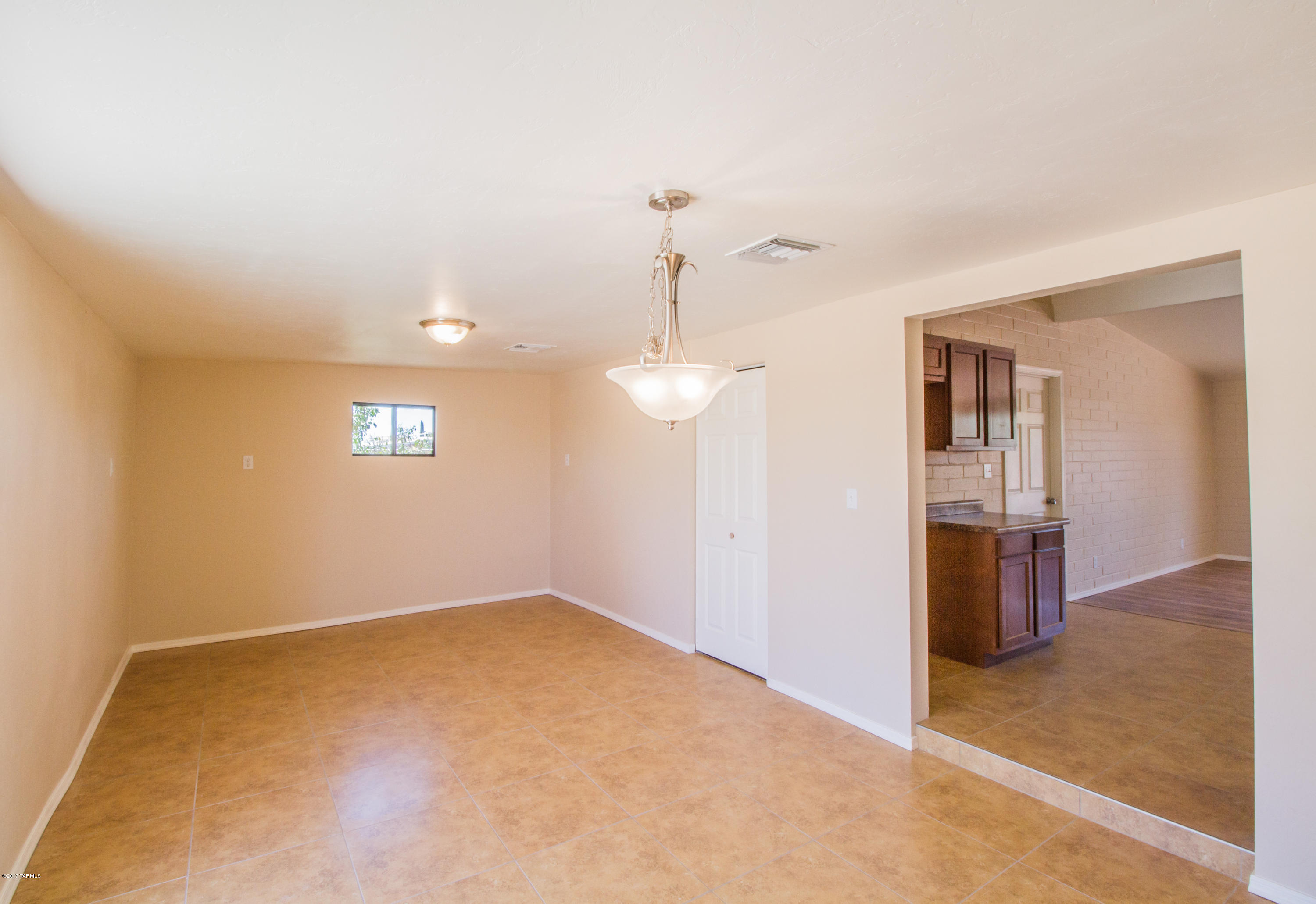 2002 West Saxony Road Tucson, AZ 85713 - Photo 10 of 22 wooden floor in an empty room with a window