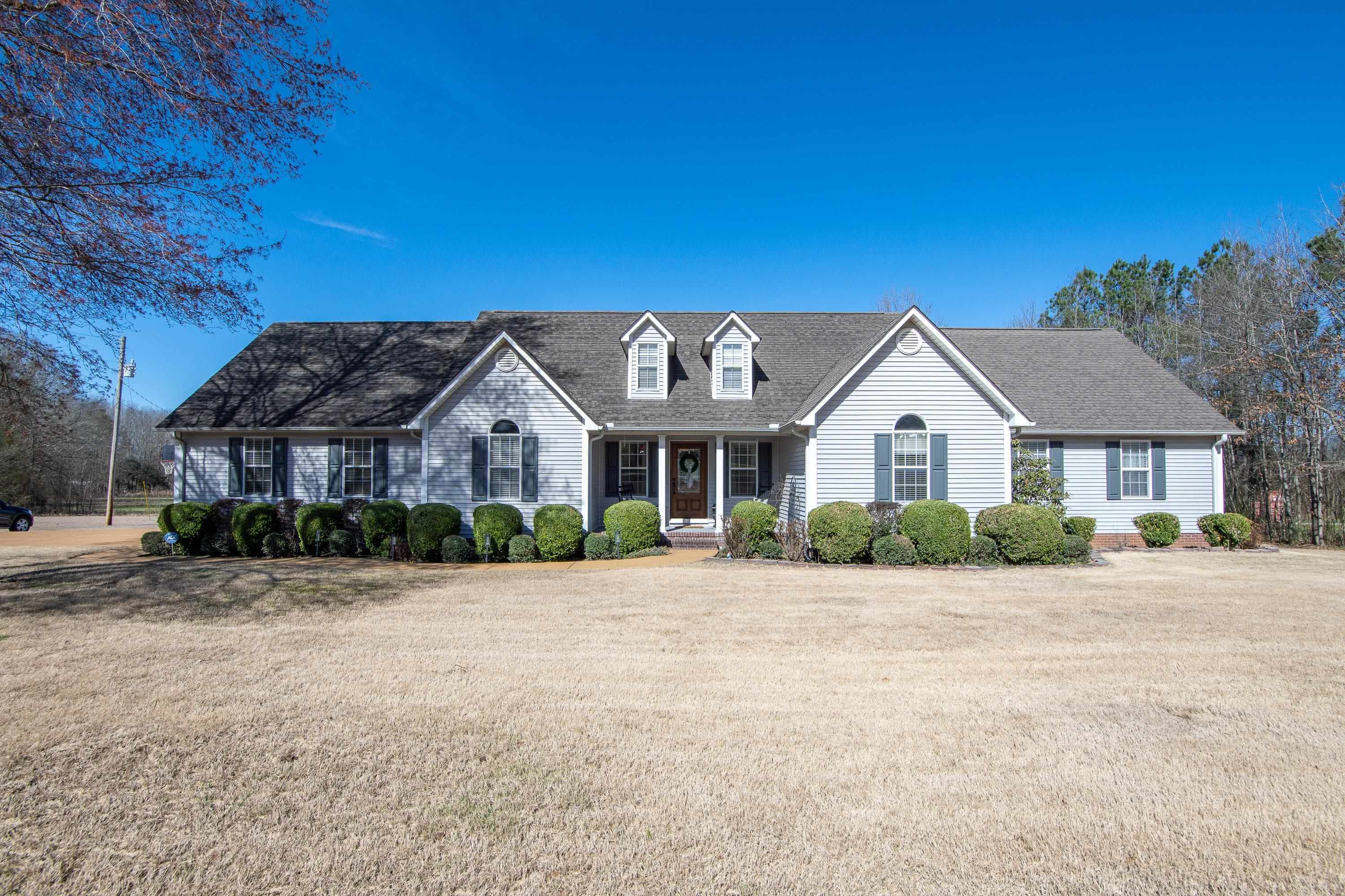 6843 Michie Pebble Hill Road Michie, TN 38357 - Photo 1 of 25 a front view of a house with a yard