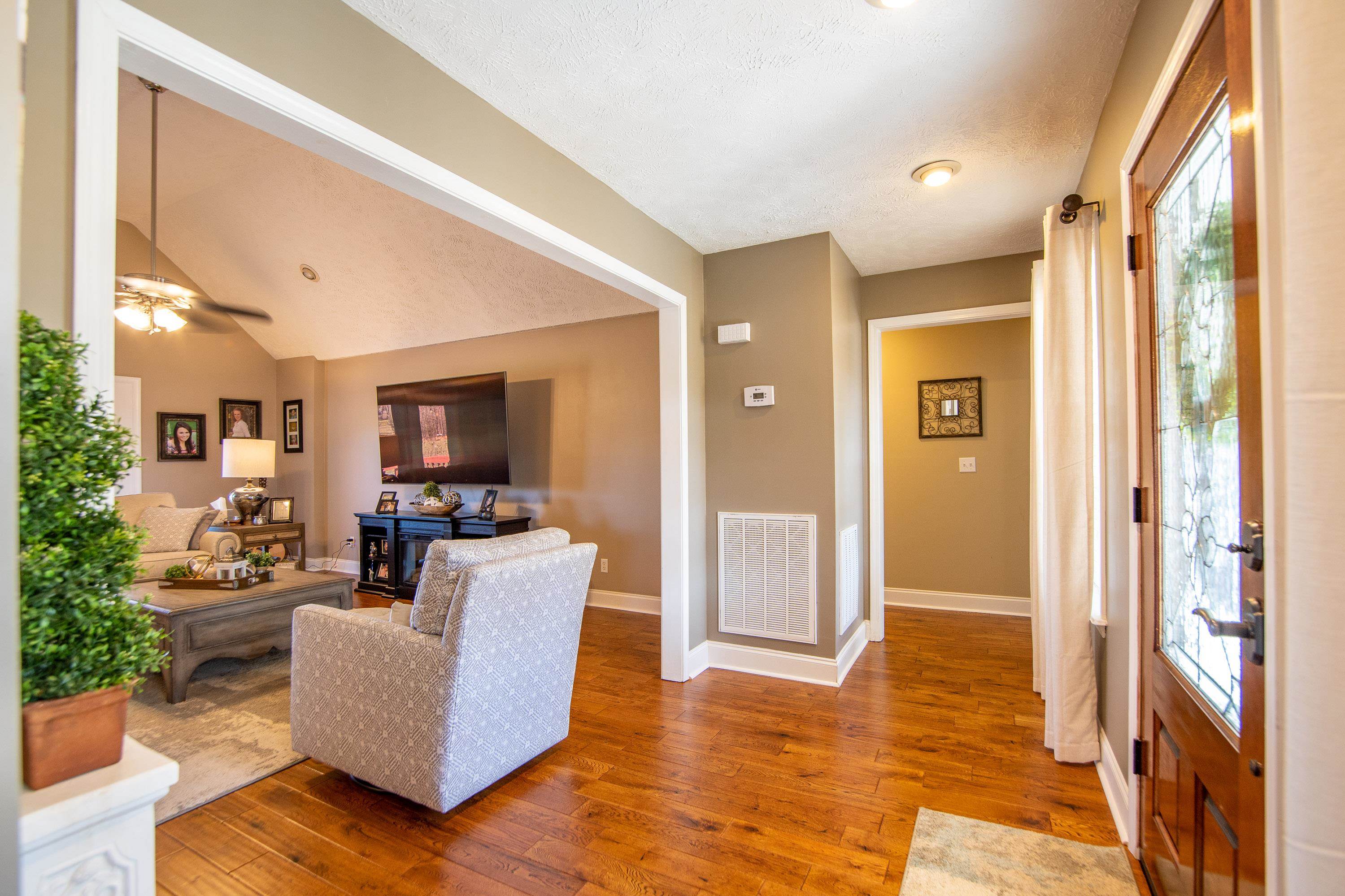 6843 Michie Pebble Hill Road Michie, TN 38357 - Photo 11 of 25 a living room with furniture and a flat screen tv