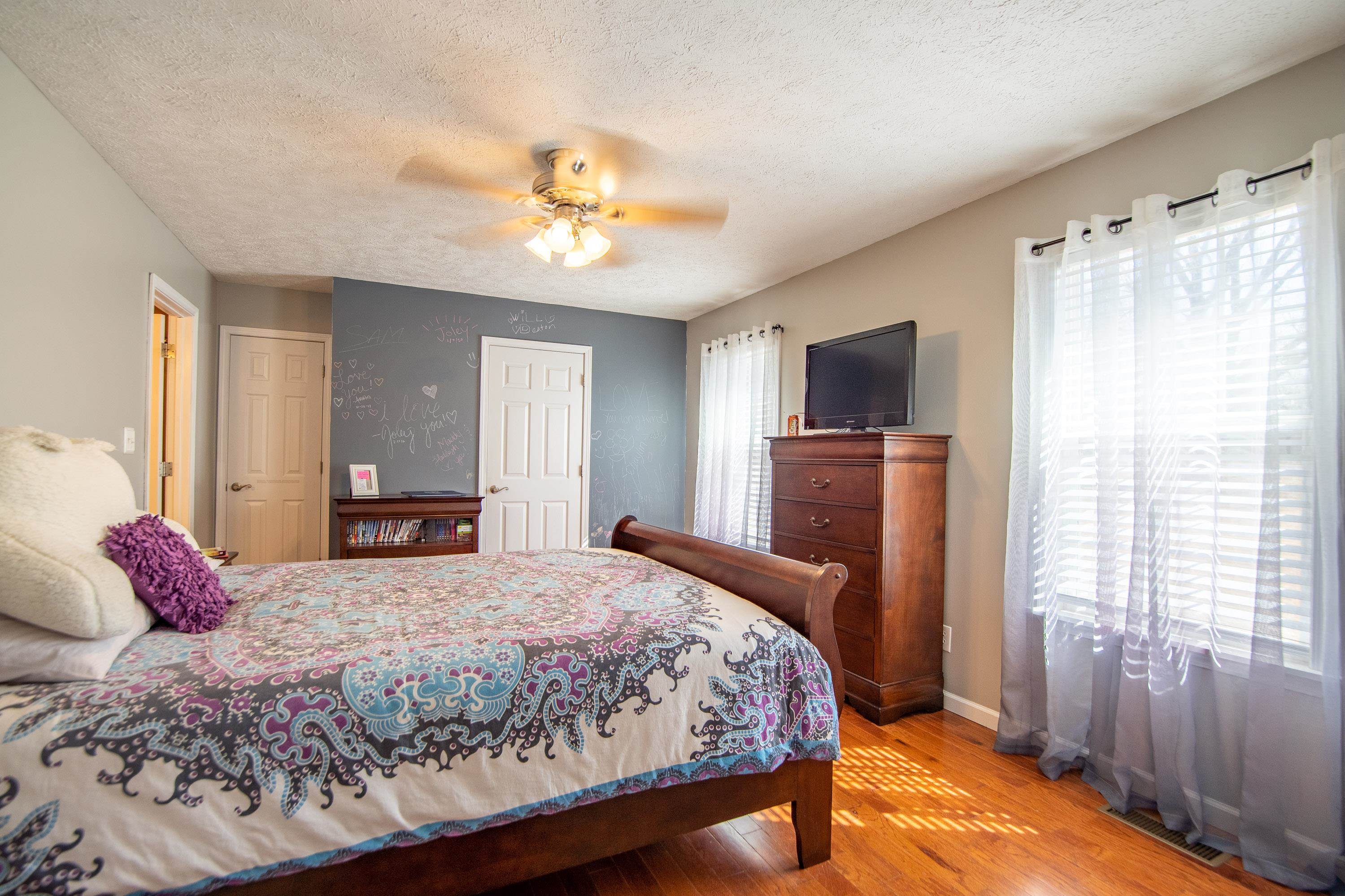 6843 Michie Pebble Hill Road Michie, TN 38357 - Photo 17 of 25 a bedroom with a large bed and a tv