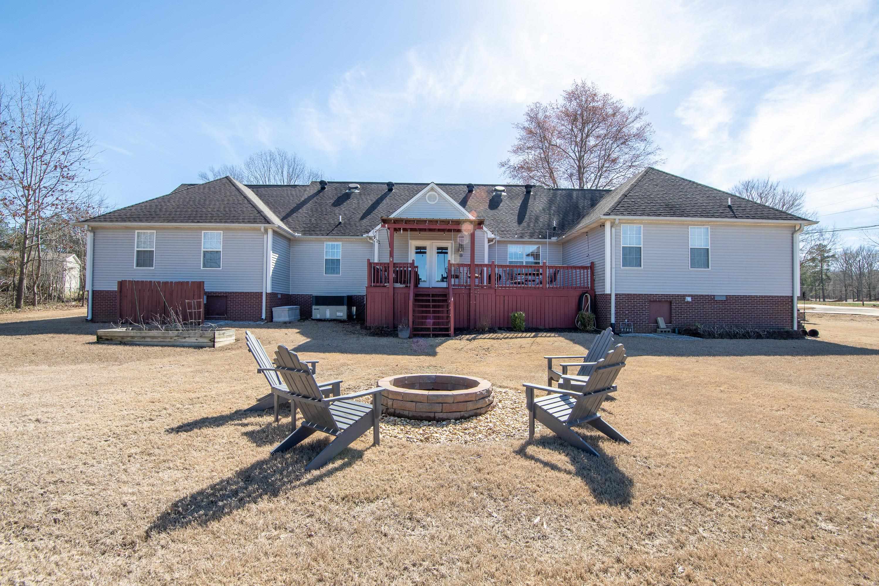6843 Michie Pebble Hill Road Michie, TN 38357 - Photo 22 of 25 a swimming pool with outdoor seating and yard