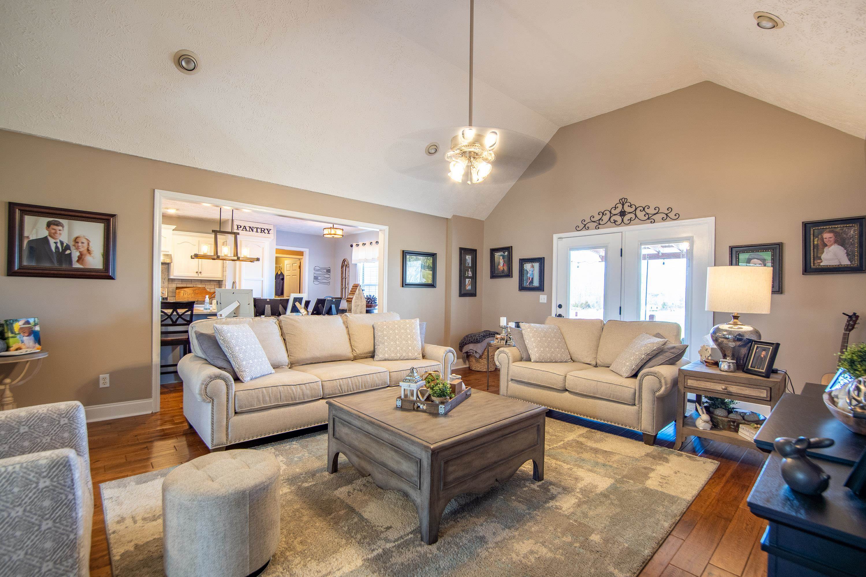 6843 Michie Pebble Hill Road Michie, TN 38357 - Photo 7 of 25 a living room with furniture chandelier and view of kitchen
