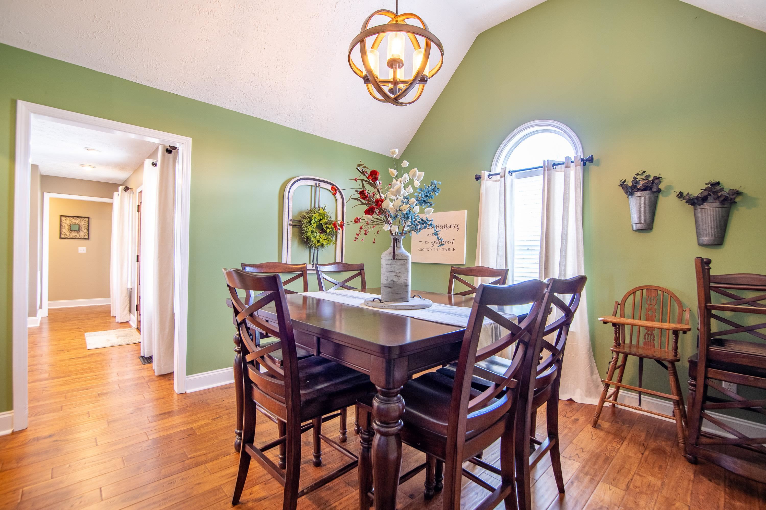 6843 Michie Pebble Hill Road Michie, TN 38357 - Photo 8 of 25 a view of a dining room with furniture wooden floor and a chandelier