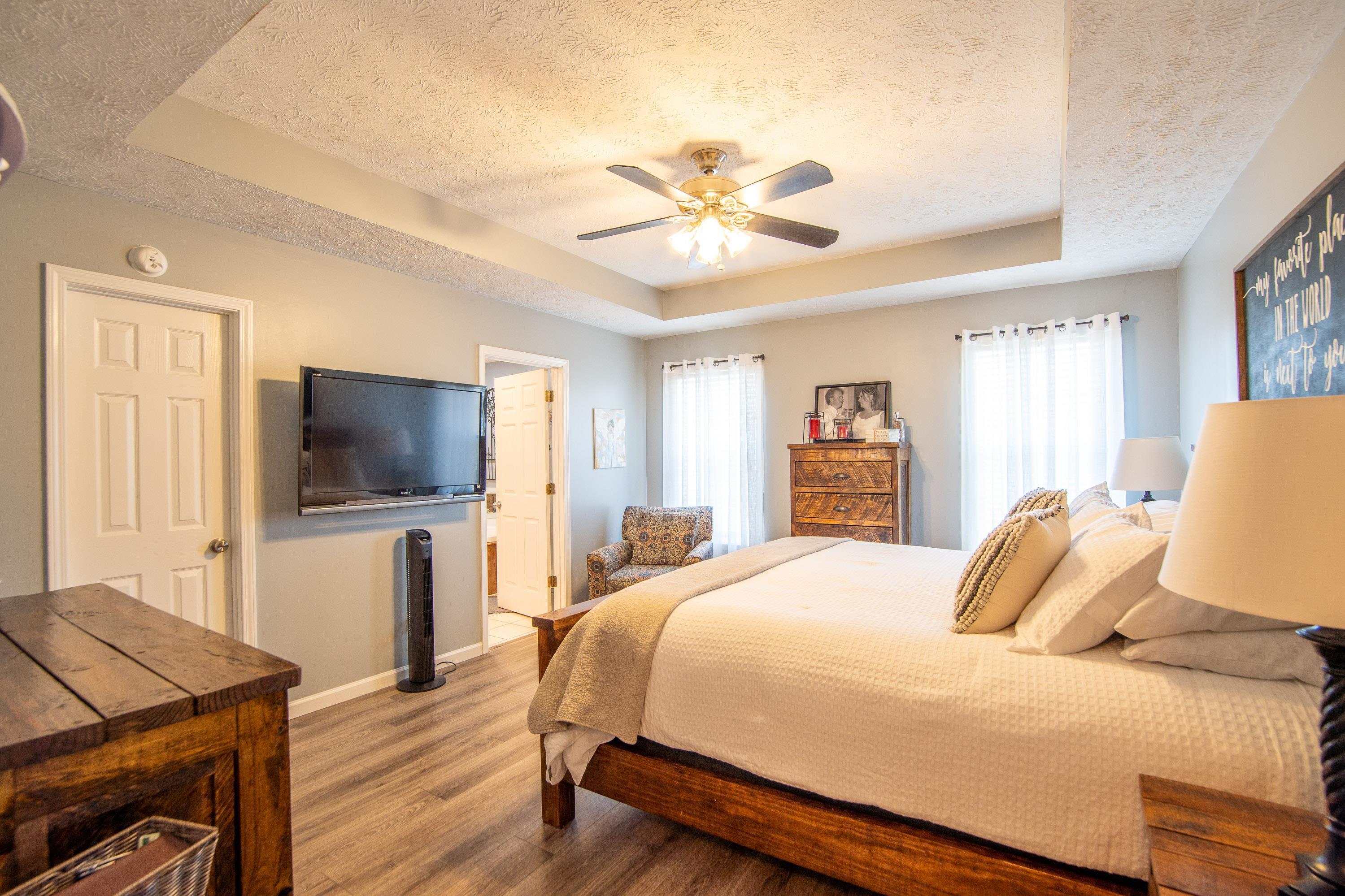 6843 Michie Pebble Hill Road Michie, TN 38357 - Photo 9 of 25 a bedroom with a bed and a flat screen tv