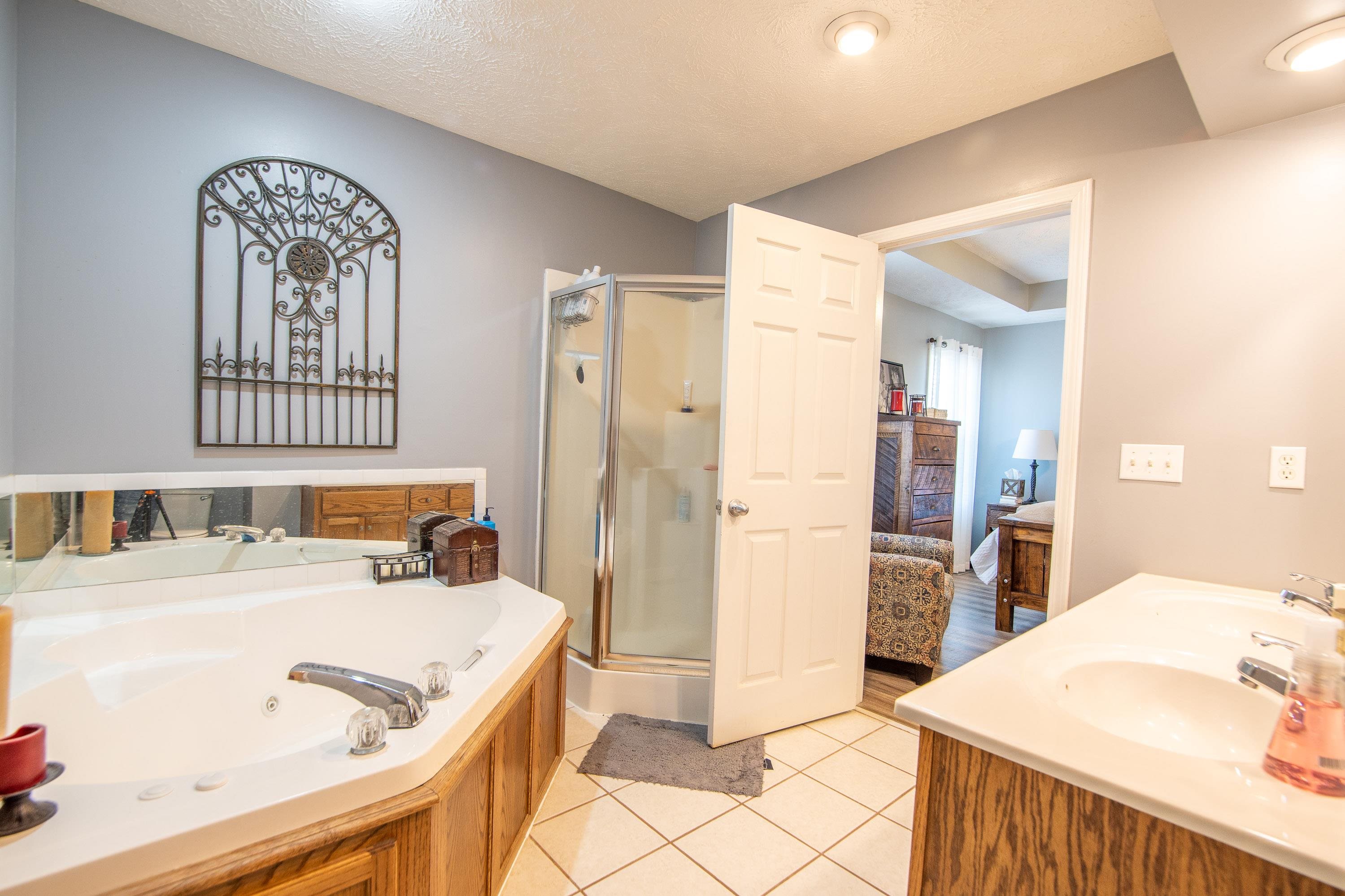 6843 Michie Pebble Hill Road Michie, TN 38357 - Photo 10 of 25 a en suite bathroom with a sink and a mirror