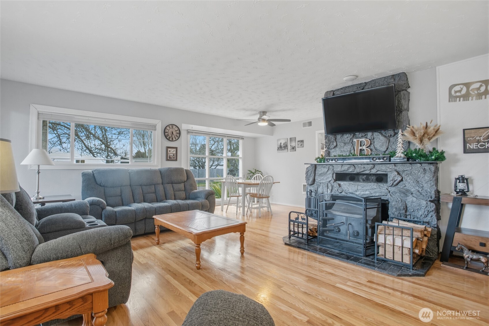 2748 Field Street Longview, WA 98632 - Photo 13 of 39 a living room with furniture a flat screen tv and a fireplace