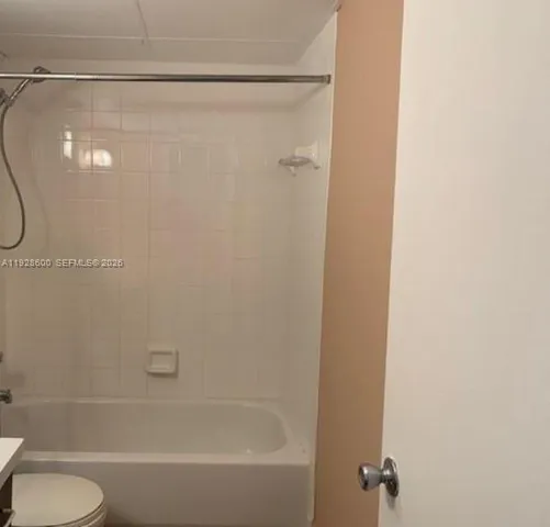 a bathroom with a shower and a toilet