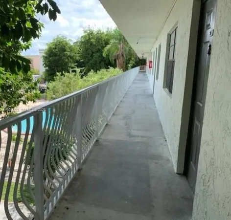 a view of a balcony with wooden floor