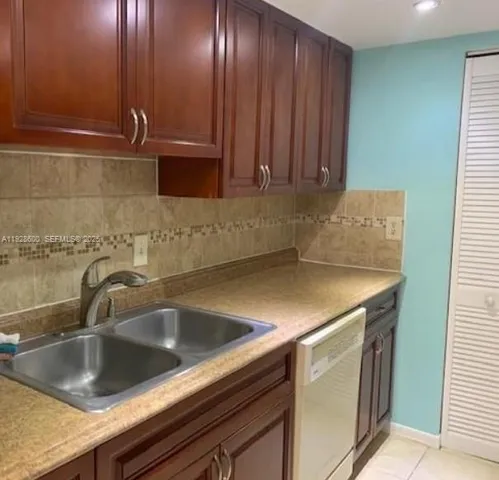 a kitchen with a sink and cabinets