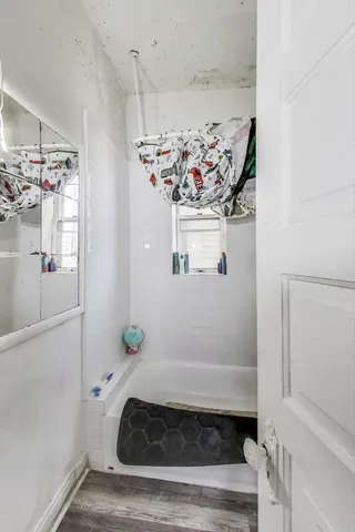 a bathroom with a bathtub and shower