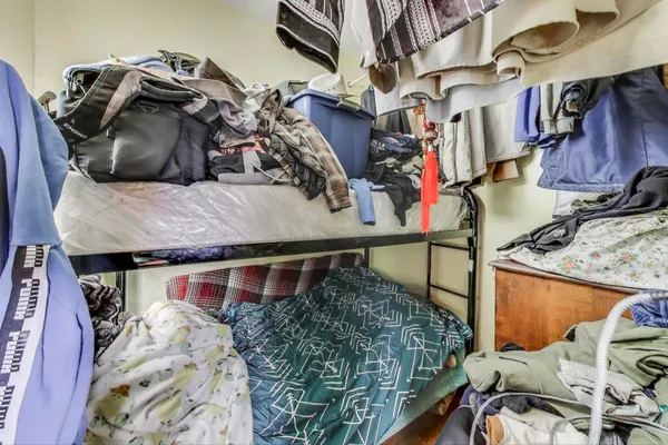 a bedroom with furniture and a wooden floor