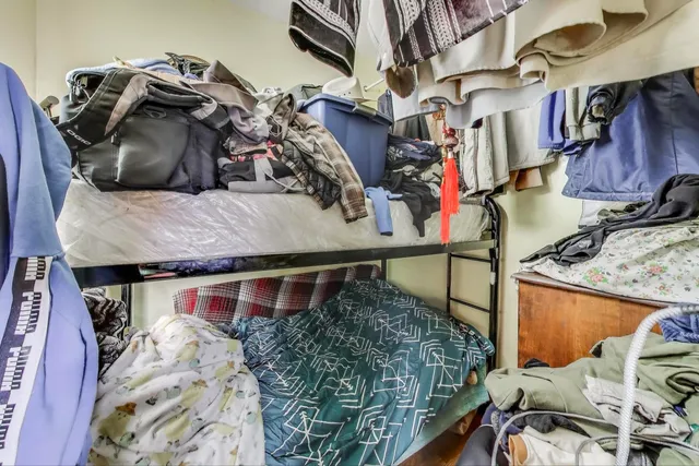 a bedroom with furniture and a wooden floor