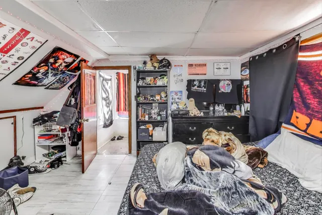 a bedroom with a bed and a painting on the wall