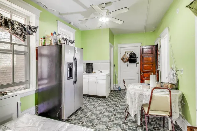 a living room with furniture chandelier and a flat screen tv