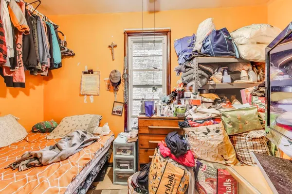 a bedroom with a bed and flat screen tv