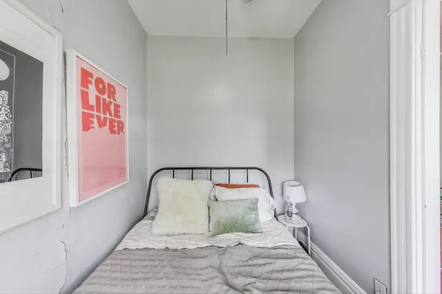 a bedroom with a bed and a mirror