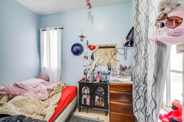 a bedroom with a bed and a window