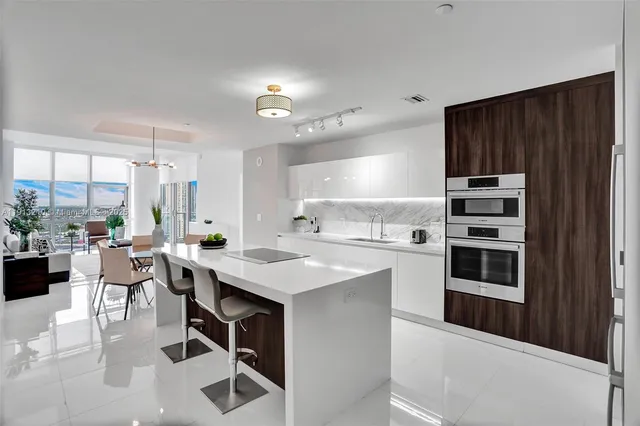 a kitchen with a table chairs stove and cabinets