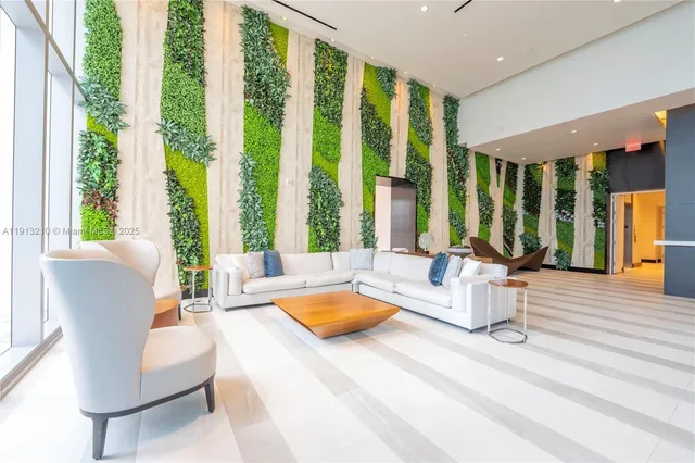 a living room with furniture and large windows