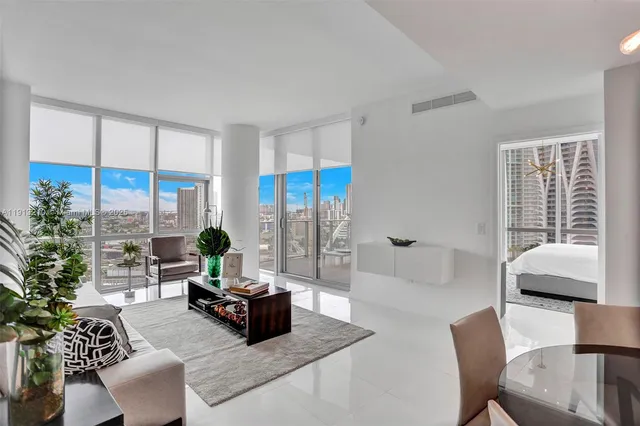 a living room with furniture and a large window