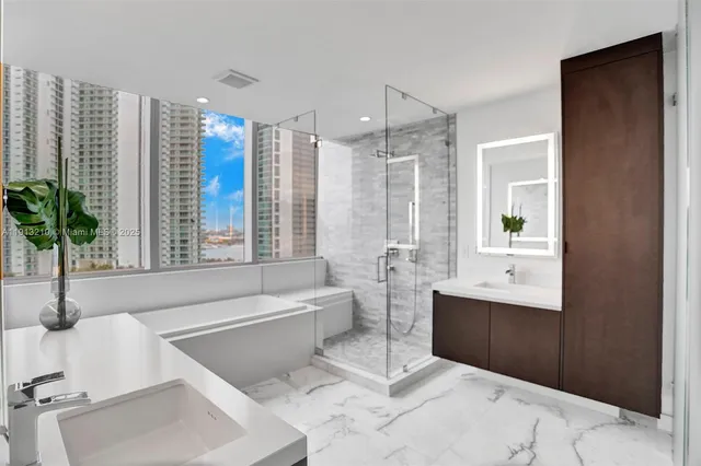 a spacious bathroom with a tub sink and mirror