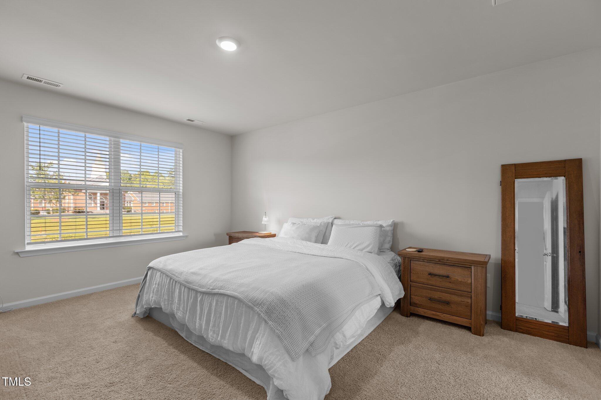 3641 Drafton Drive Raleigh, NC 27610 - Photo 5 of 10 a bedroom with a bed and a window