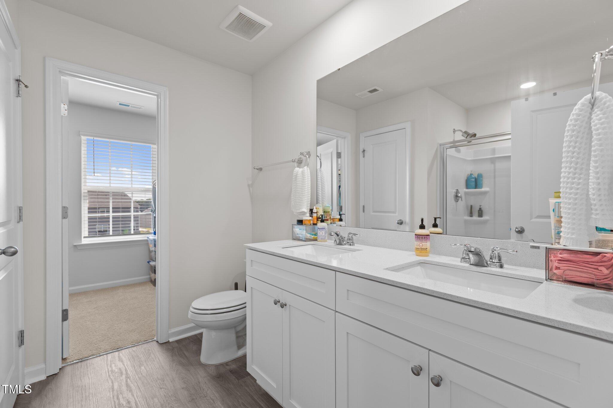 3641 Drafton Drive Raleigh, NC 27610 - Photo 7 of 10 a bathroom with a toilet a sink a tub and mirror