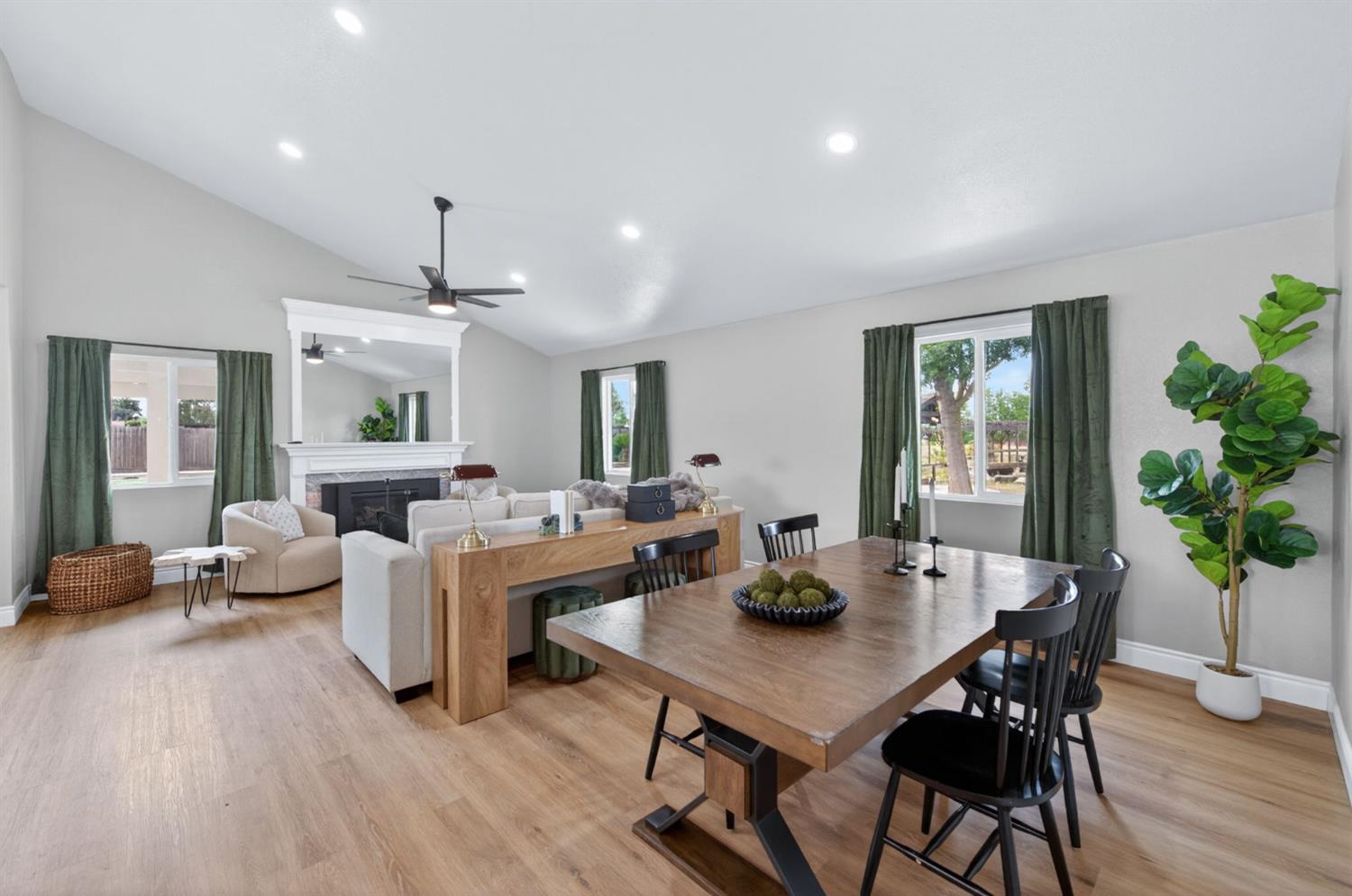 16564 Monreal Road Madera, CA 93636 - Photo 10 of 59 a view of a dining room with furniture window and wooden floor