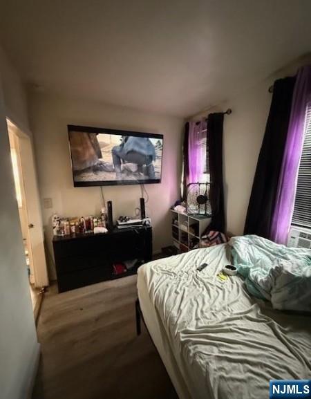 286 North 6th Street Prospect Park, NJ 07508 - Photo 9 of 15 a bedroom with a bed and a flat screen tv