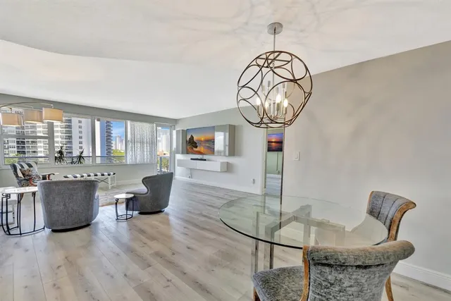 a living room with furniture a window and a dining table