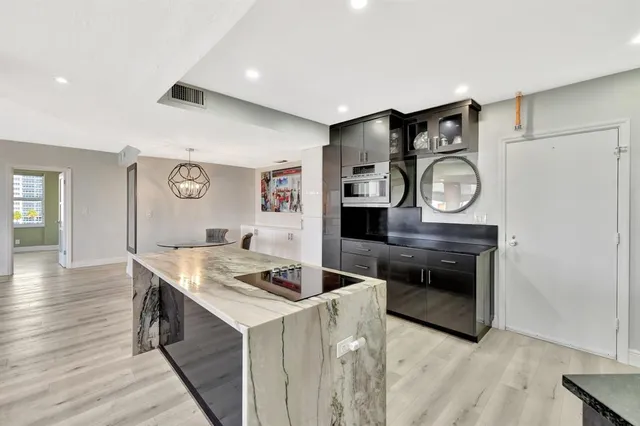 a kitchen with stainless steel appliances granite countertop a refrigerator and a stove