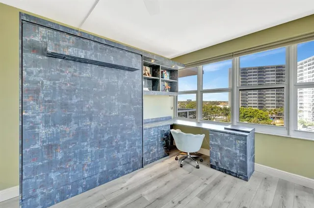 a living room with a wooden floor and a table