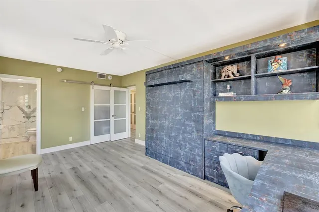 a view of empty room with a window and wooden floor